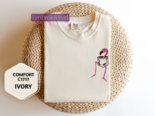 a white t - shirt with a pink flamingo on it