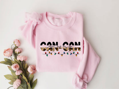A pink sweatshirt with the text "GON GON" printed on it, along with a floral design.