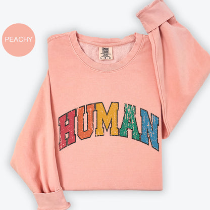 a pink shirt with the word human printed on it