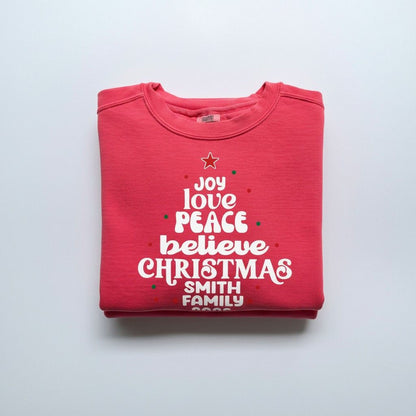 A red sweatshirt with white text printed on it, folded over itself.