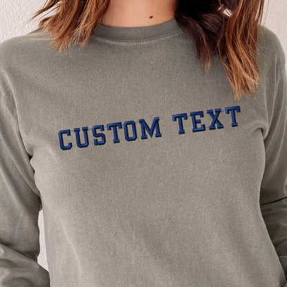 a woman wearing a gray sweatshirt with the word custom text on it