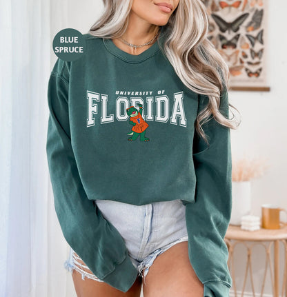 a woman wearing a green florida sweatshirt and denim shorts