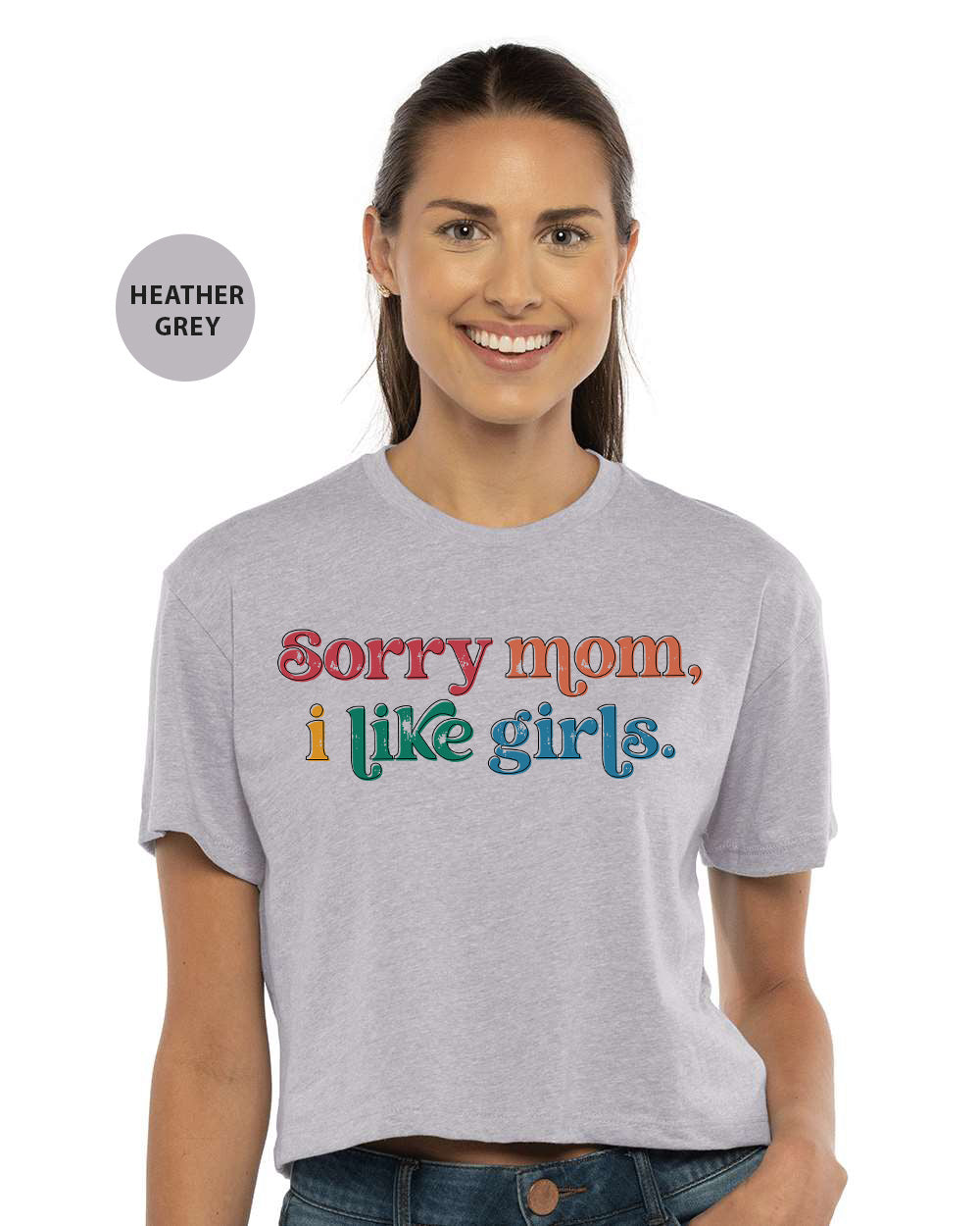 a woman wearing a grey shirt that says sorry mom like girls