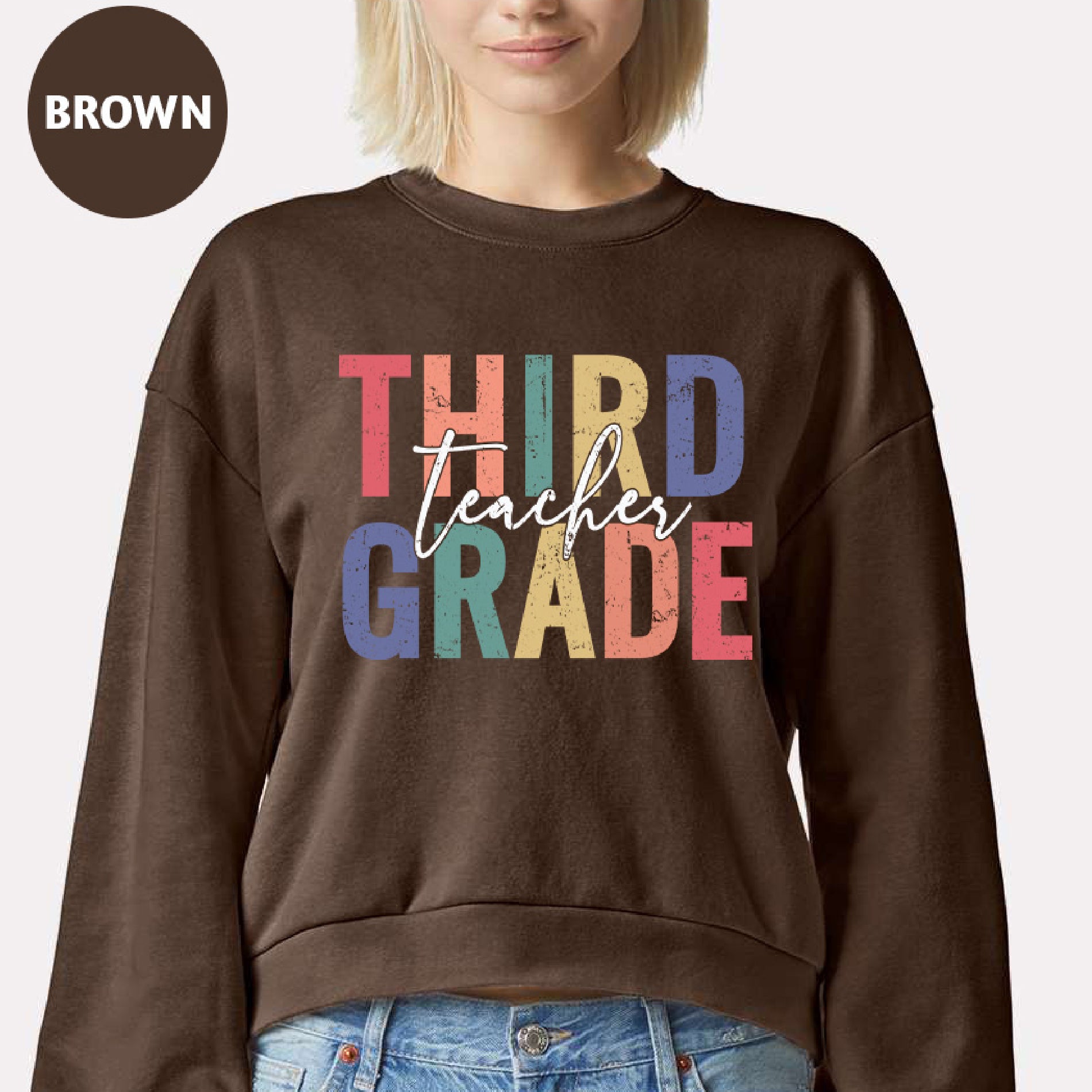 a woman wearing a brown sweatshirt that says third grade