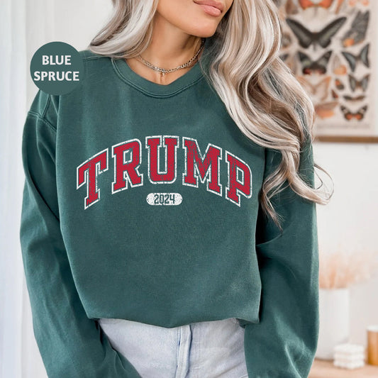 a woman wearing a green sweatshirt with the word trump printed on it