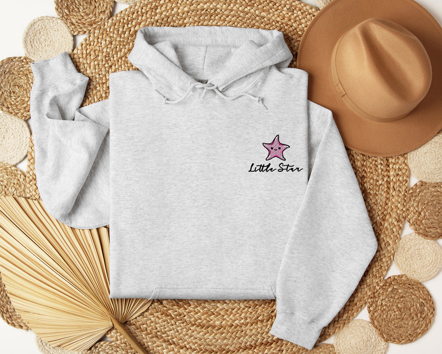 a white hoodie with a pink star on it