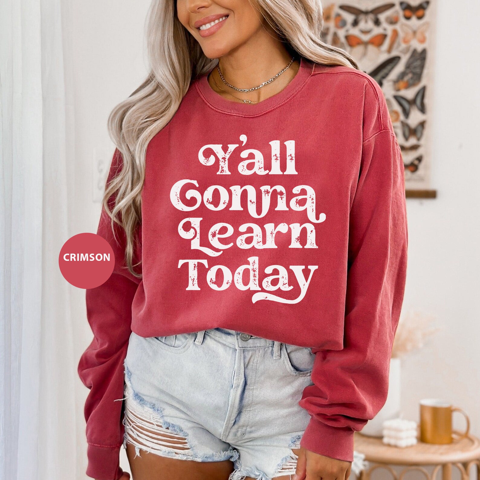 a woman wearing a red sweater that says y'all gonna learn today