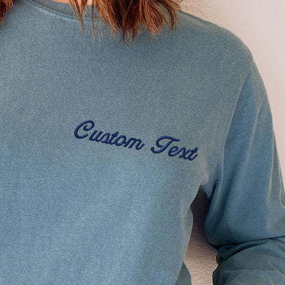 a woman wearing a blue shirt with the word custom text on it