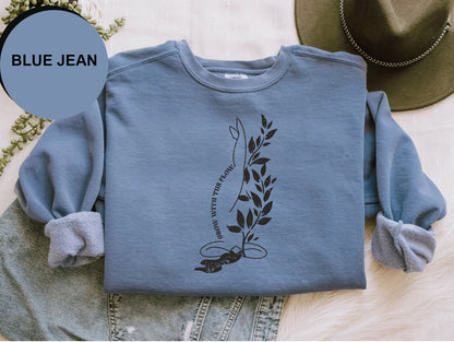 a blue jean shirt with a picture of a plant on it