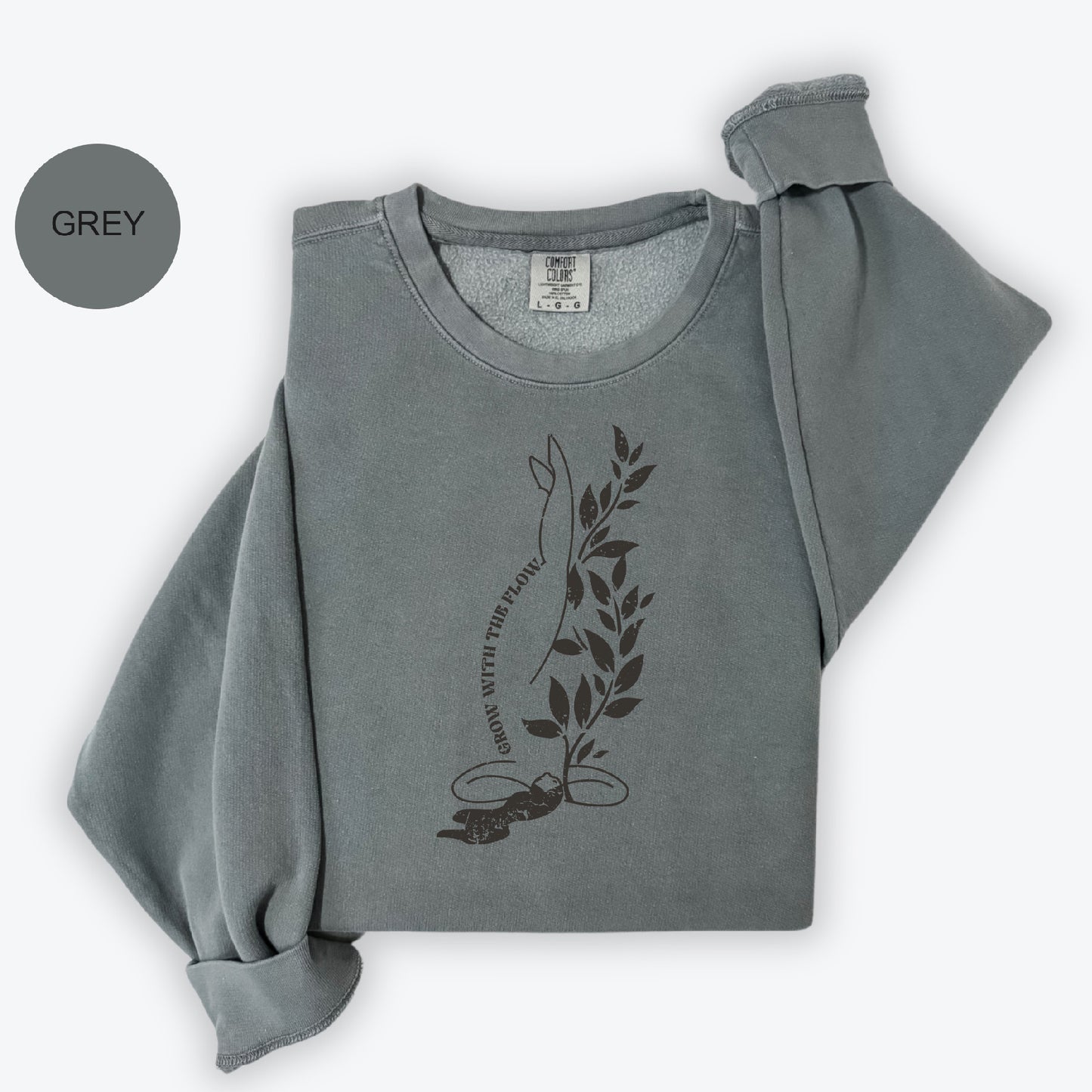 a grey sweatshirt with a leaf design on it