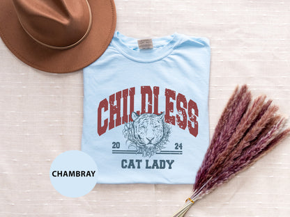 a blue shirt with a cat lady on it next to a hat