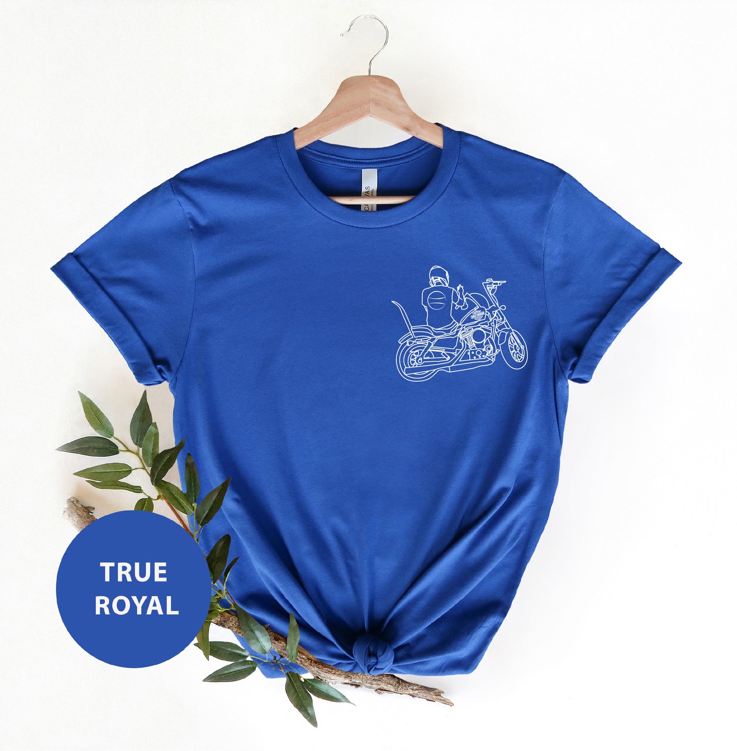 a blue t - shirt with a picture of a man riding a motorcycle