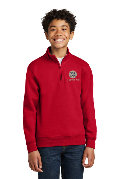 a young boy wearing a red sweatshirt and smiling