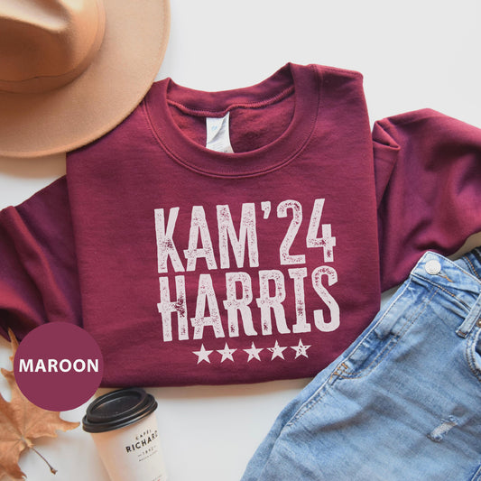 a maroon shirt that says kam'24 and has stars on it