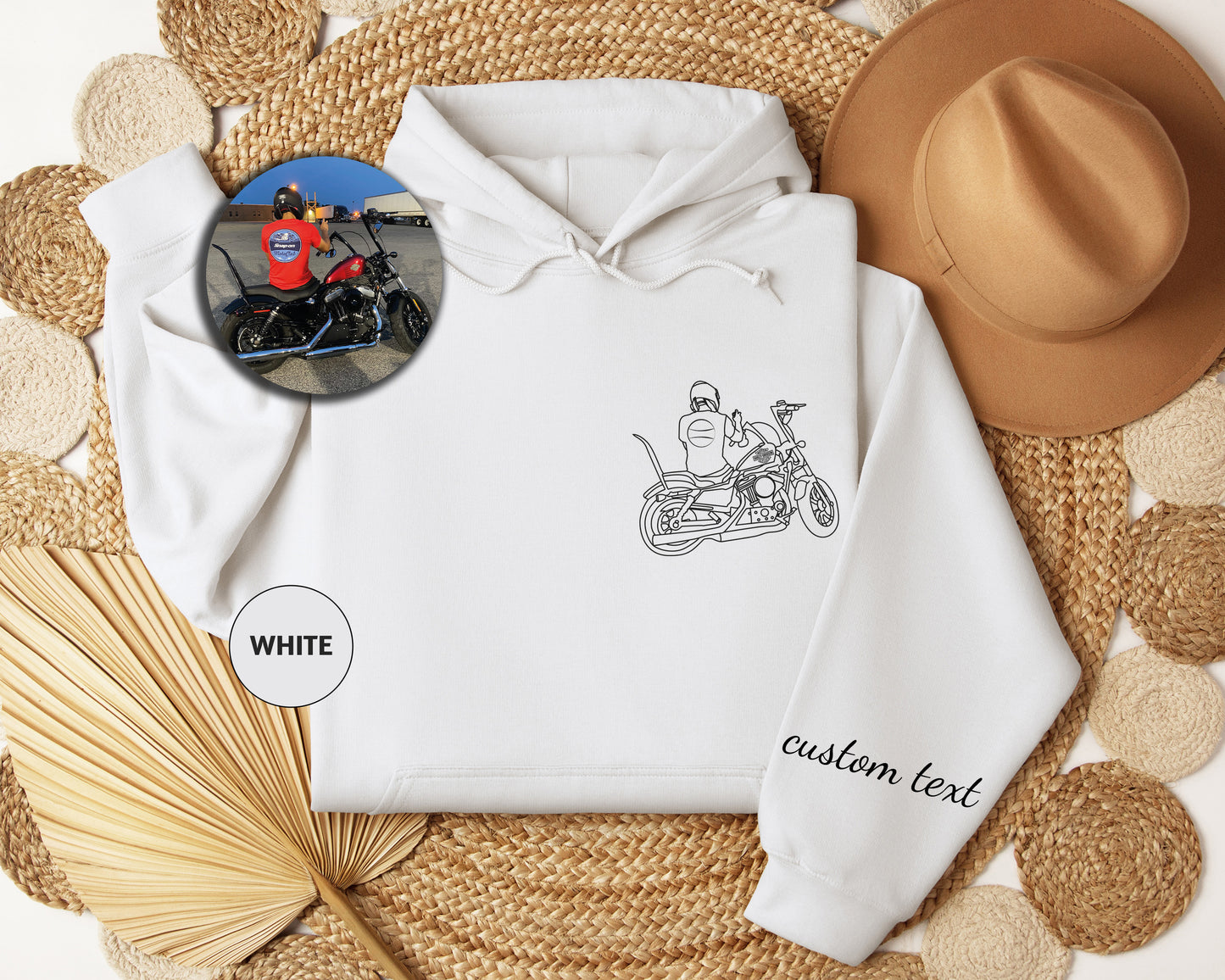 a white hoodie with a picture of a man on a motorcycle