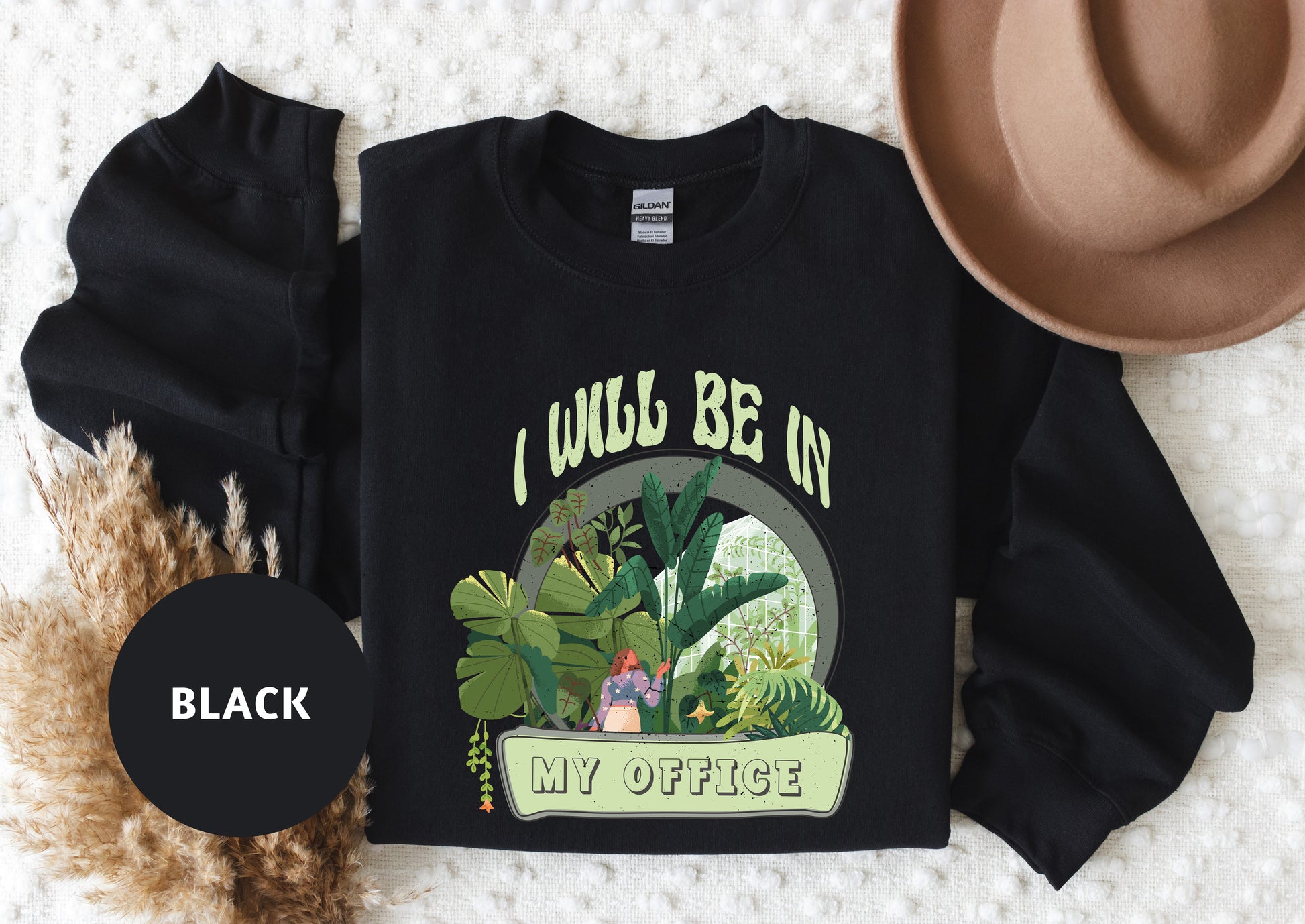 a t - shirt that says i would be on my office next to a hat