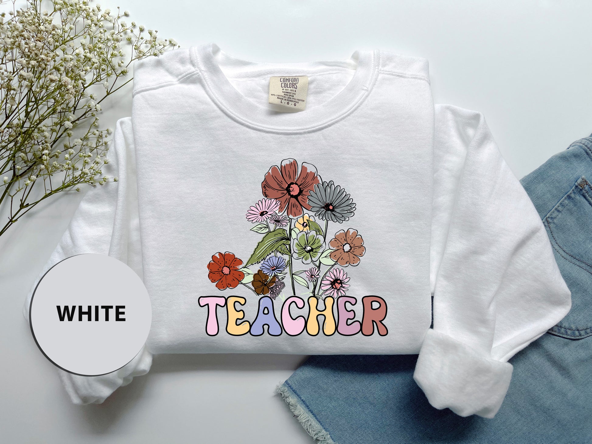 a white t - shirt with a picture of flowers on it