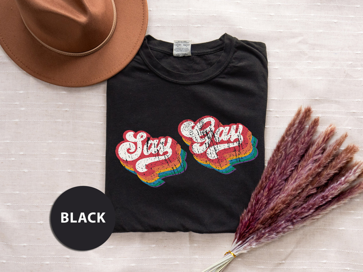 a hat, t - shirt, and dried grass on a bed