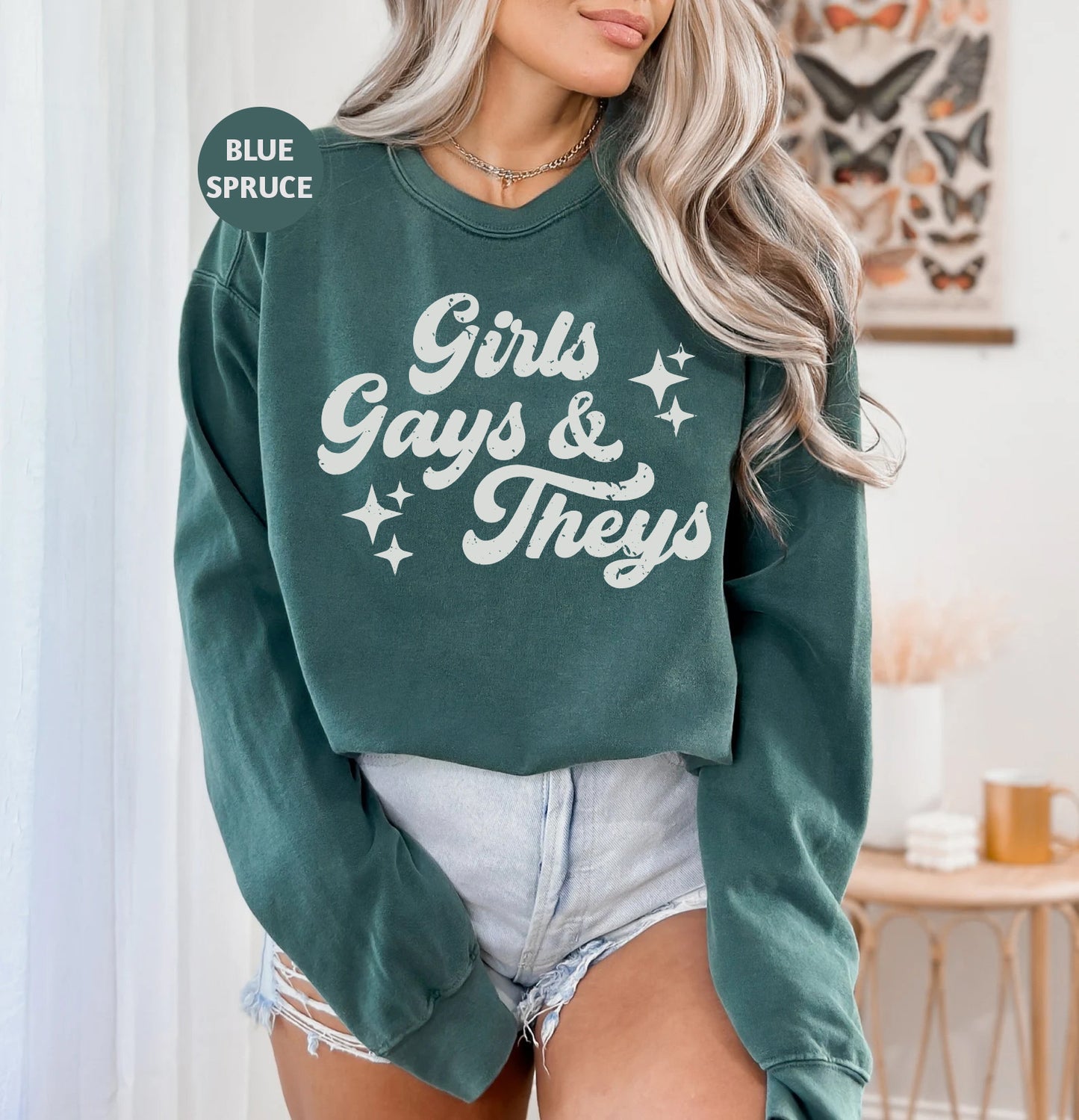 a woman wearing a green sweatshirt that says girls, guys and they