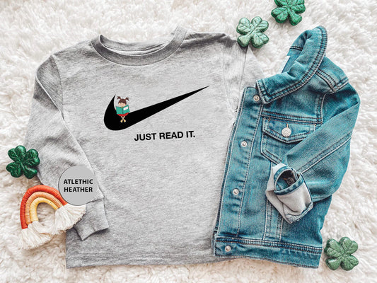 a shirt that says just read it next to a pair of jeans