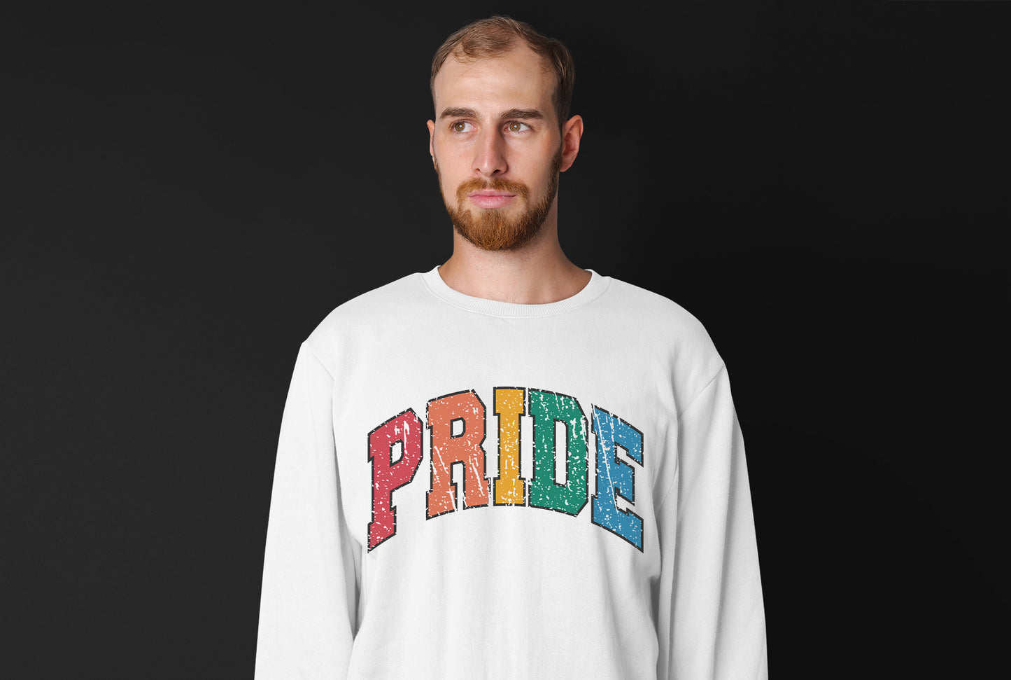 a man with a beard wearing a pride shirt