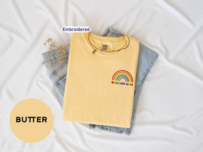 a yellow shirt with a rainbow embroidered on it