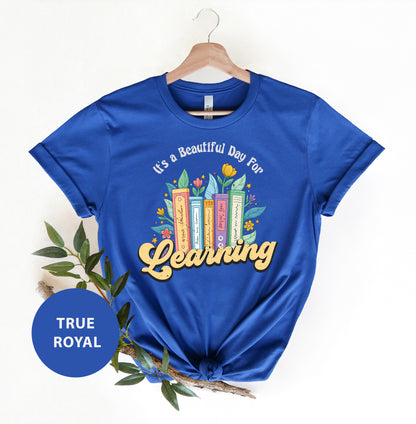 a blue t - shirt with the words learning on it