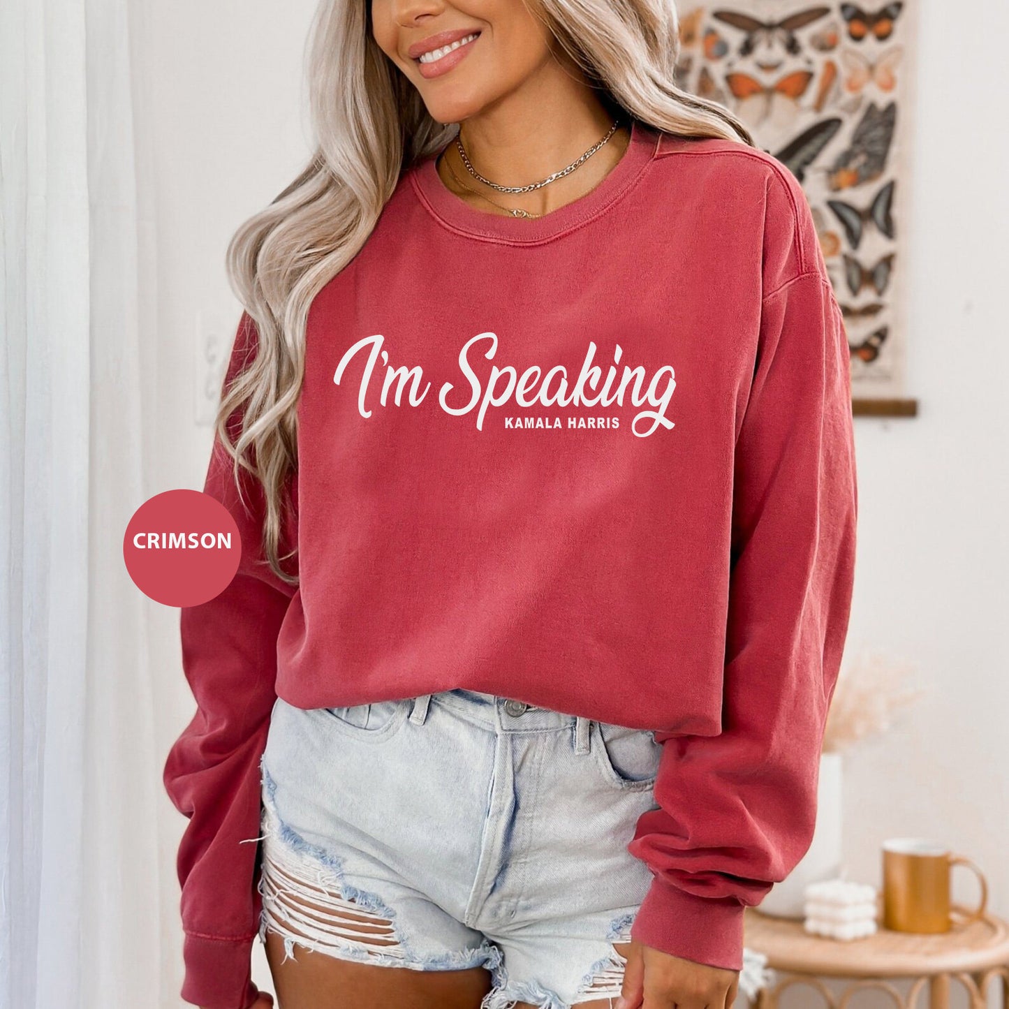 a woman wearing a red sweatshirt that says i'm speaking