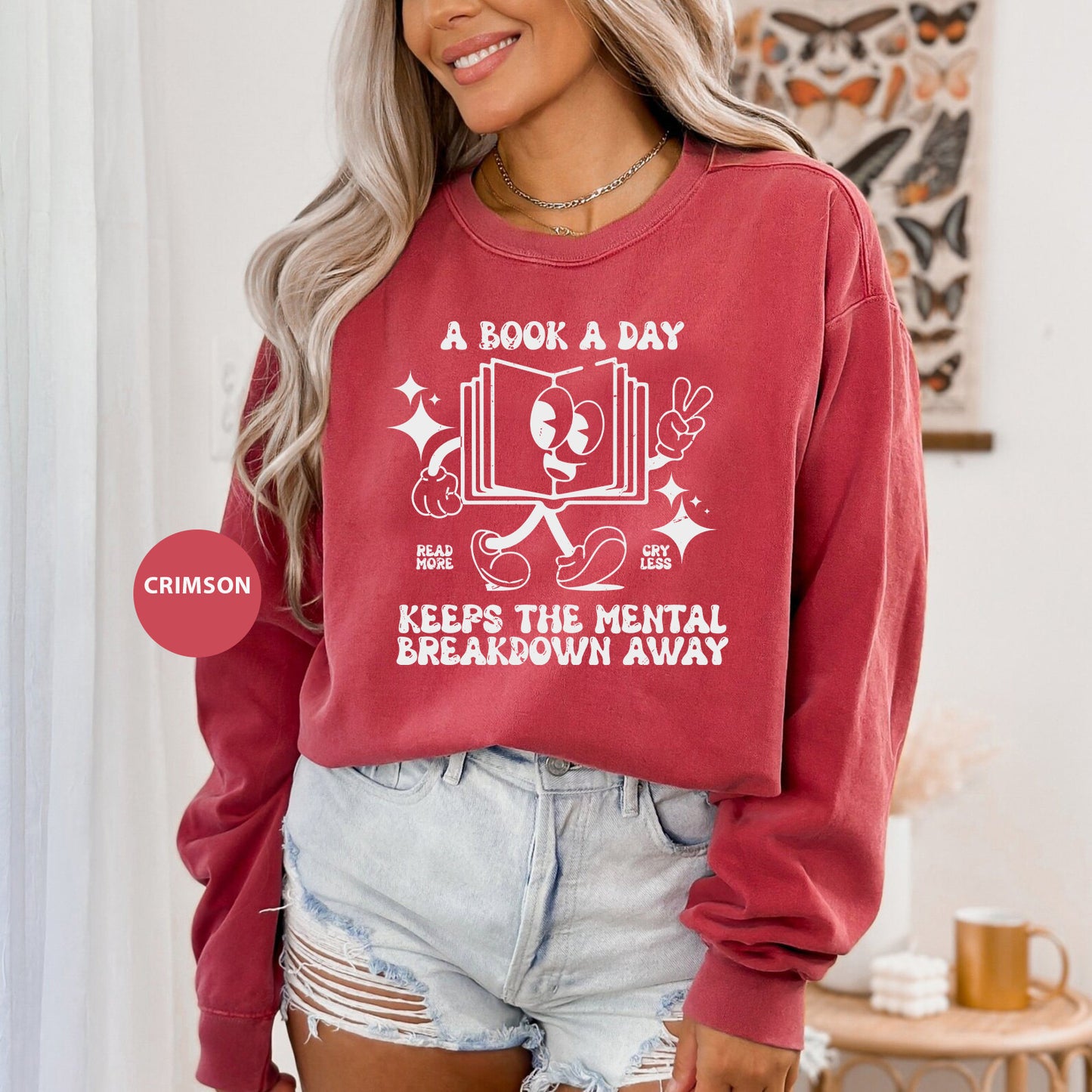 a woman wearing a book a day sweatshirt