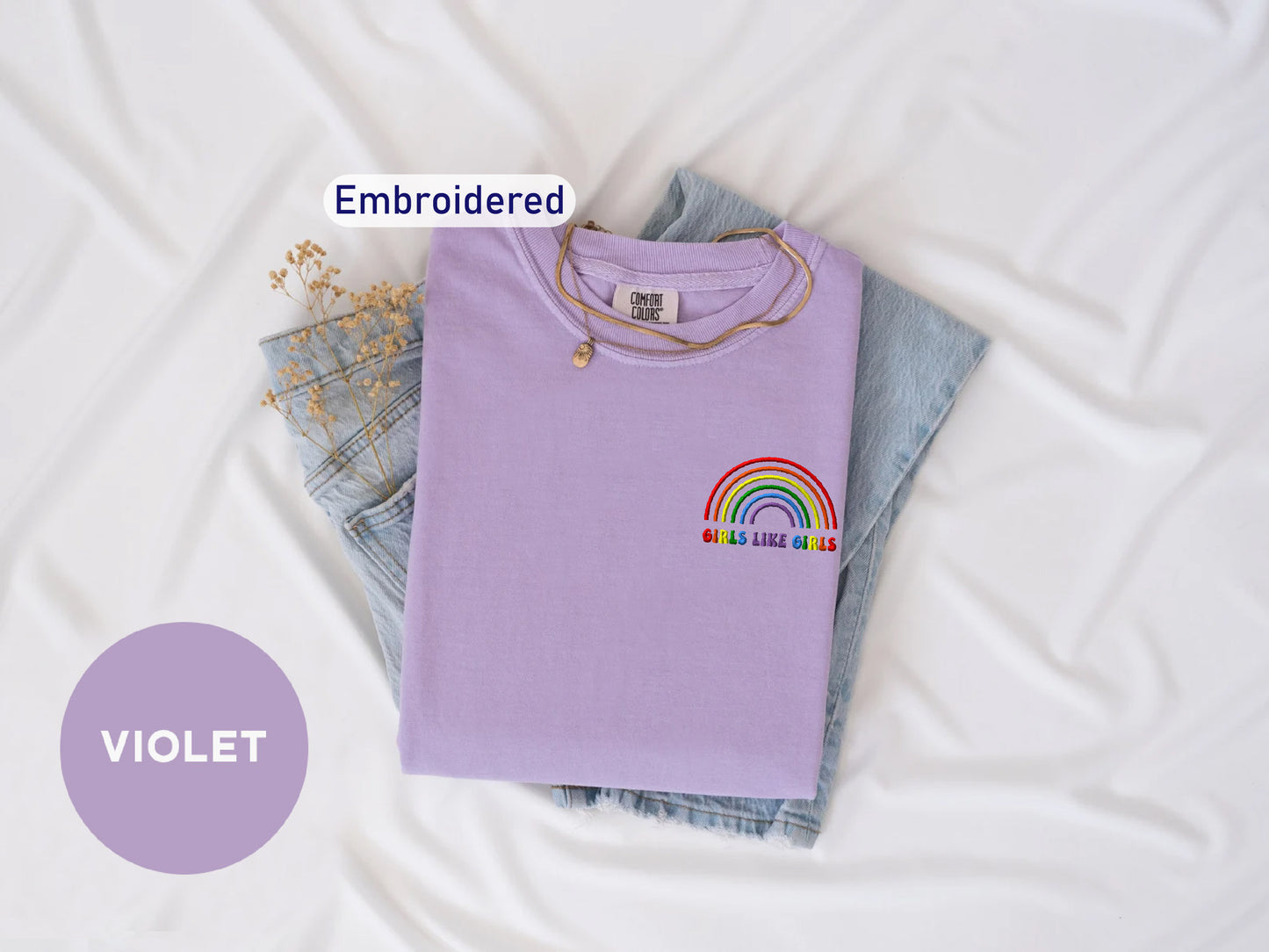 a purple shirt with a rainbow embroidered on it