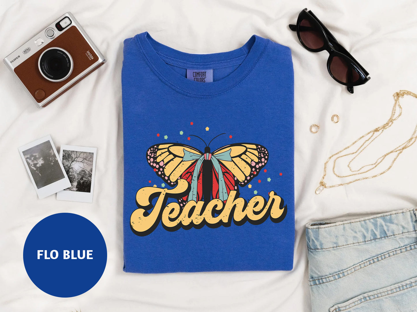 a blue t - shirt with a butterfly on it