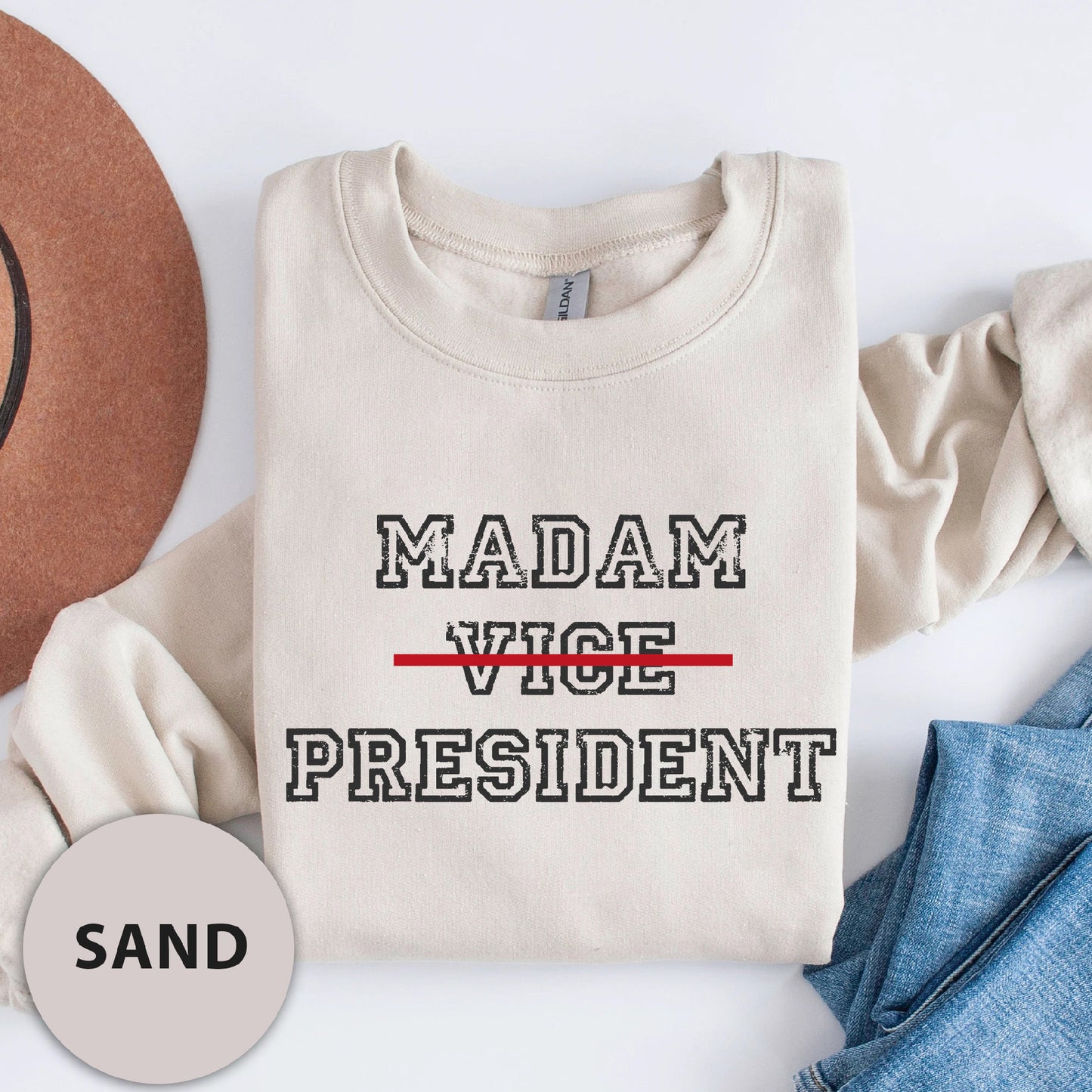 a t - shirt that says madam vice president next to a hat