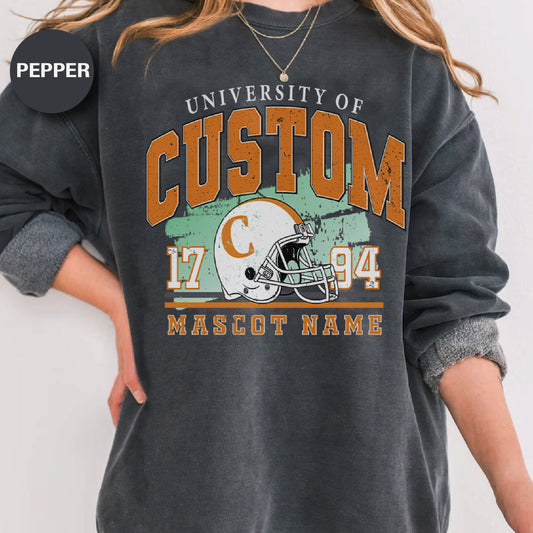 a woman wearing a sweatshirt with a football helmet on it