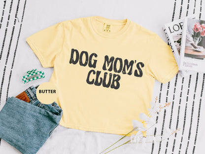 a yellow dog mom's club shirt next to a pair of jeans