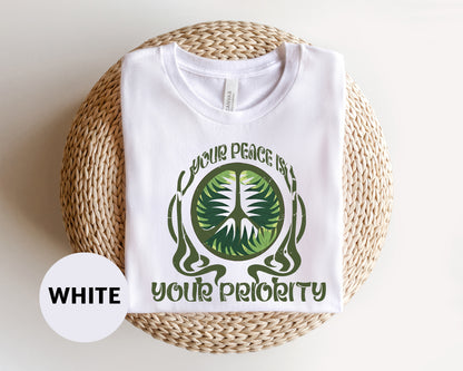 a white t - shirt with a green tree on it