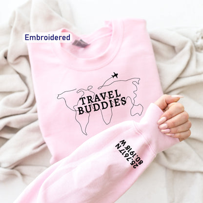 a person holding a pink shirt with the words travel buddies on it