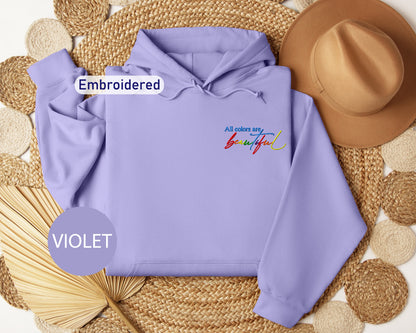 a purple hoodie with embroidered words and a straw hat