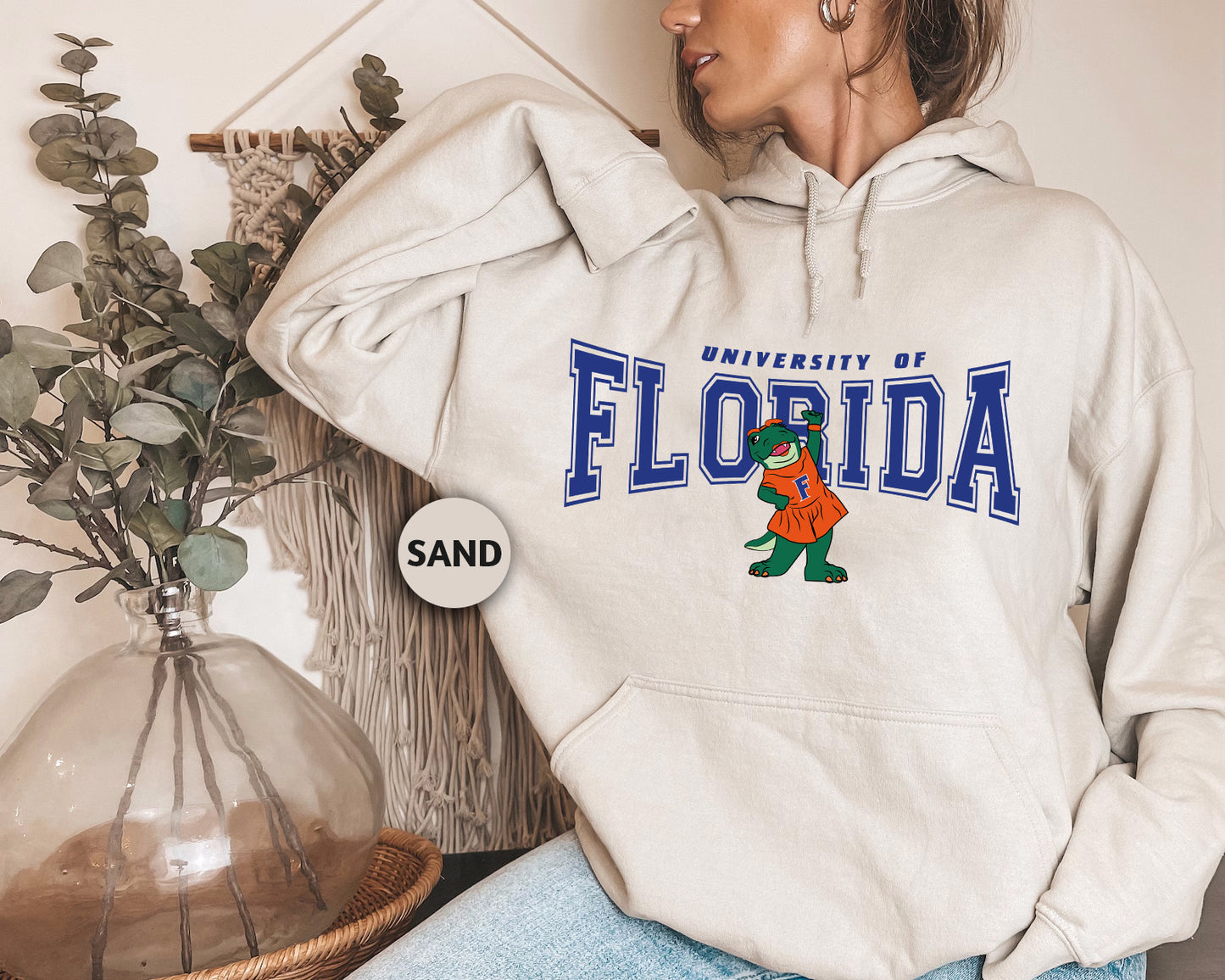 a woman wearing a white hoodie with the university of florida on it