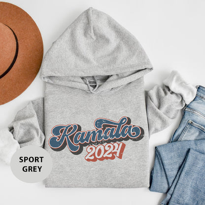 a gray hoodie with the words kansas on it next to a pair of jeans