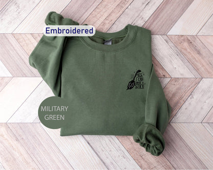 a military green sweatshirt with an embroidered eagle on it