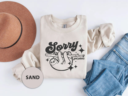 a t - shirt that says sorry and a hat next to it