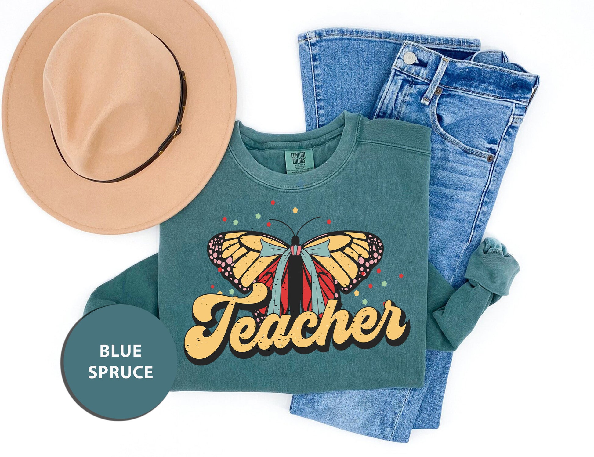 a hat, jeans, and a t - shirt with a butterfly on it