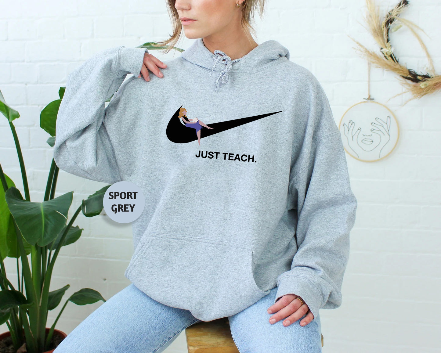 a woman sitting on a stool wearing a nike hoodie