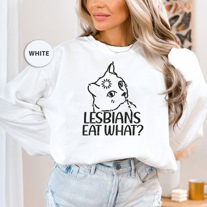 a woman wearing a white sweatshirt that says lesbians eat what?