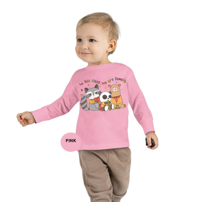 a little girl wearing a pink shirt with a panda and panda bear on it