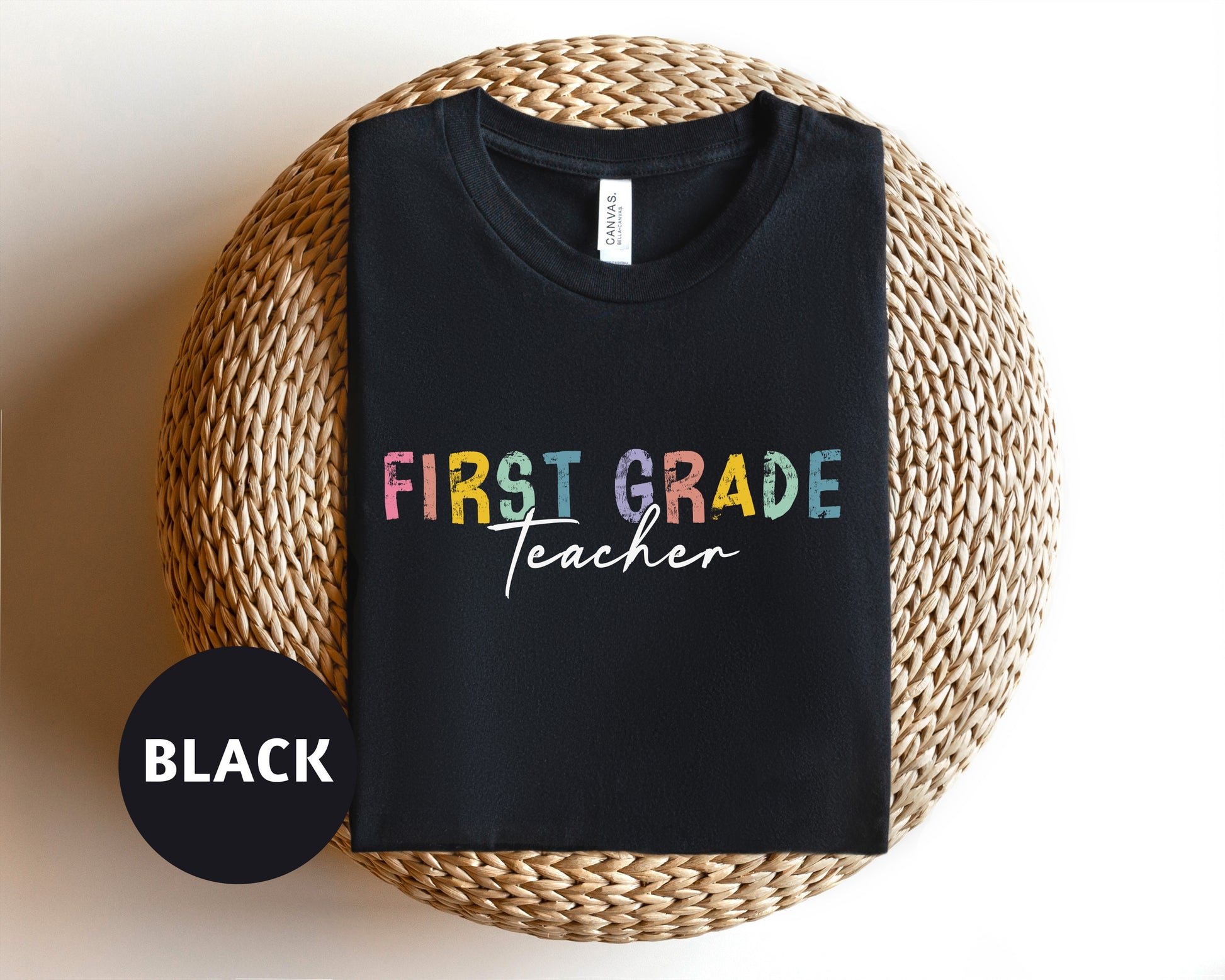 a black t - shirt with the words first grade teacher on it