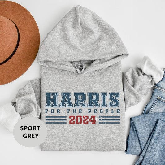 a gray hoodie with the words harris for the people on it next to a