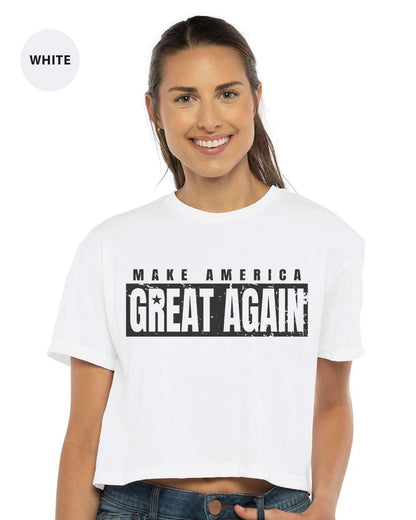 a woman wearing a white crop top that says make america great again