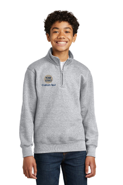 a young boy wearing a grey sweatshirt with a blue and white logo on the chest