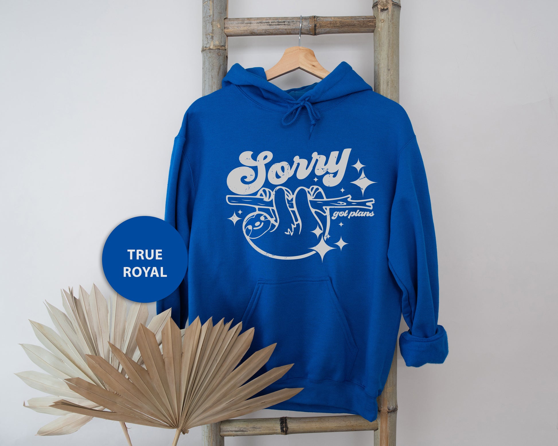 a blue sweatshirt with the words sorry on it